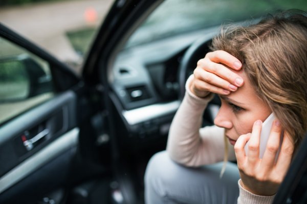 person on a cell phone call after being in a car accident